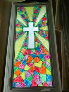 a stained glass window with a cross on it