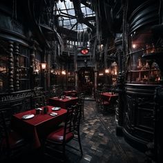 a dimly lit restaurant with red tables and chairs