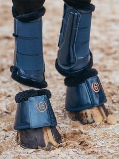 the legs and boots of a horse wearing winter gear