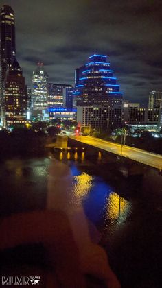 the city skyline is lit up at night