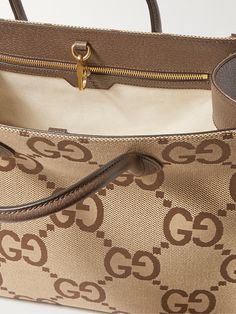 Gucci's neat rectangular tote bag is crisscrossed with the label's new maximalist take on the 'GG' monogram. It's panelled from canvas with leather through the top handles, sides and base and fitted with an optional webbing shoulder strap, too. Gucci Rectangular Bag With Gold-tone Hardware, Rectangular Monogram Canvas Luxury Bag, Gucci Rectangular Bag For Everyday Use, Gucci Rectangular Everyday Bag, Chic Gucci Rectangular Bag, Gucci Shopping Bag With Double Handle, Gucci Double Handle Shopping Bag, Gucci Double Handle Bag With Top Carry Handle, Gucci Bag With Top And Double Carry Handles