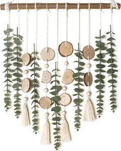 a wind chime hanging on the side of a wooden pole with leaves and tassels