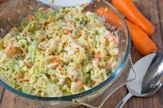 a glass bowl filled with coleslaw and carrots