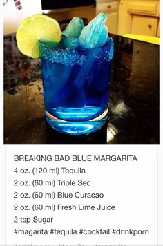 a blue margarita with ice and lemon wedges