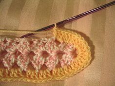 a crocheted bag with a knitting needle in it