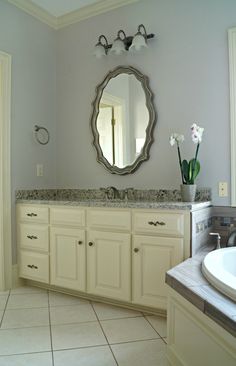 a bathroom with a large mirror above the sink