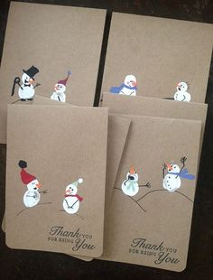 four thank you cards with snowmen and birds on them, all decorated in brown paper