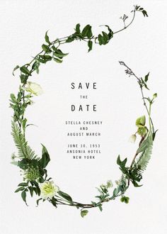 a wedding save the date card with greenery and flowers in a circle on white paper