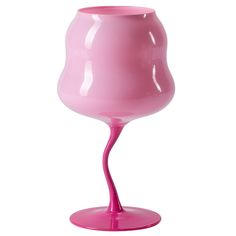 a pink vase sitting on top of a table