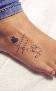 a woman's foot with a heart and heartbeat tattoo on it