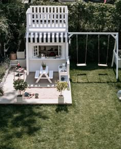 an aerial view of a backyard with a swing set, table and chairs in it