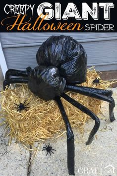 a giant spider made out of plastic sitting on top of hay with the caption creepy giant halloween spider