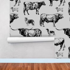 a cow and calf wallpaper mural in a living room with wood flooring on the walls