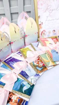 there are many princess themed items on the table with cards in front of them, including tiaras