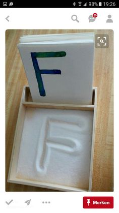 an open box with the letter f painted on it