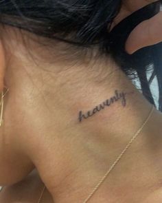 the back of a woman's neck that says heavenly