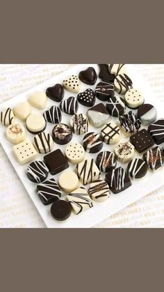 a white plate topped with lots of different types of chocolates