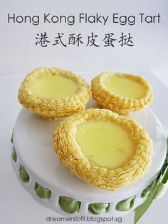 three small desserts sitting on top of a white plate with chinese writing above them