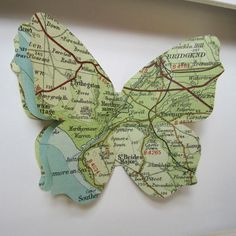 a paper butterfly is hanging on the wall