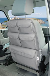 the interior of a car with two seats facing each other and an ocean in the background