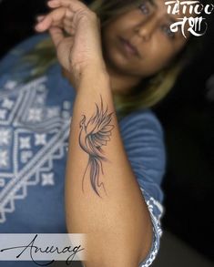 a woman with a tattoo on her arm