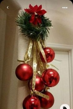 a bunch of red ornaments hanging from the side of a door