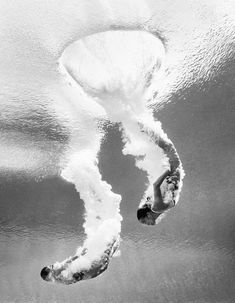 a man riding a wave on top of a surfboard