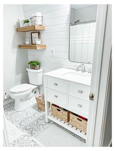 a white toilet sitting next to a sink in a bathroom under a mirror and wooden shelves