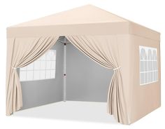 a beige tent with curtains and windows on the side, in front of a white wall