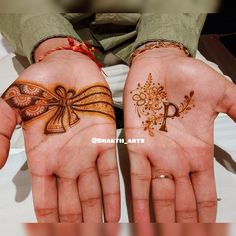 two hands with hendi designs on them, one has a bow and the other has a flower