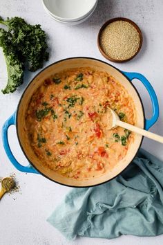 a blue pot filled with food next to other ingredients