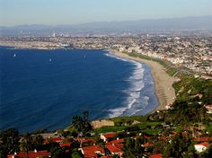 an aerial view of a city and the ocean