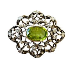 Exquisite, Victorian 14ct 14k, 585 Gold, Peridot and rose-cut diamond (4.48cts) brooch, Circa 1880 This fine, antique brooch was beautifully made around the late Victorian period.   At the centre of the brooch is a fine, 13x9mm Peridot gemstone, mounted in a gold collet setting.  The Peridot is surrounded by an open worked foliate and scalloped design frame, decorated with forty twinkling rose cut diamonds set in silver. Complete with gold pin and trombone style clasp. Hallmarks: there are four Antique Oval Diamond Brooch, Vintage Green Diamond Brooches, Victorian Rose Cut Diamond Brooches For Wedding, Victorian Brooches With Rose Cut Diamonds For Wedding, Victorian Wedding Brooches With Rose Cut Diamonds, Antique Rose Cut Diamonds Brooch For Formal Occasions, Victorian Green Jewelry With Rose Cut Diamonds, Victorian Style Green Jewelry With Rose Cut Diamonds, Green Victorian Jewelry With Rose Cut Diamonds