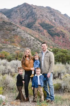 a family posing for a photo in the mountains