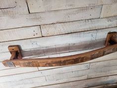 an old wooden door handle hanging on a wall