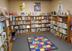 a room filled with lots of books and stuffed animals on the floor next to each other