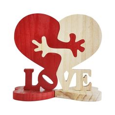 a wooden heart with the word love spelled by it's legs and two pieces of wood