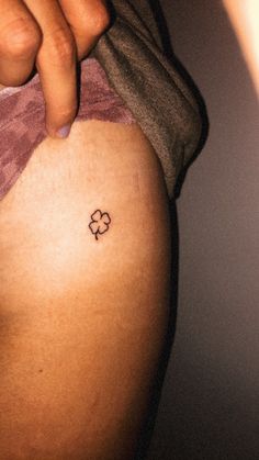 a person with a small tattoo on their stomach