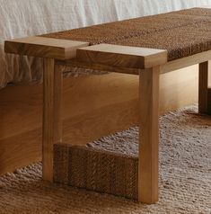 a wooden bench sitting on top of a carpeted floor