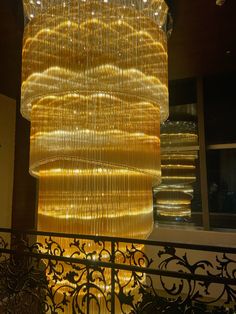 a large chandelier hanging from the ceiling in a room with metal railings