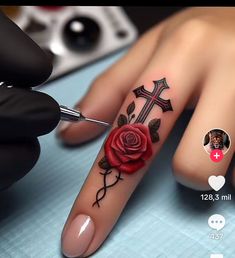 a person with a rose tattoo on their finger next to a pair of scissors and a needle