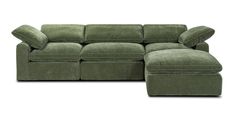 a green sectional sofa with pillows on it