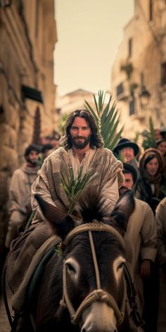 a man riding on the back of a donkey down a street