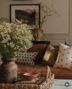 a living room filled with lots of furniture and pillows