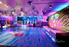 a large room with balloons and lights on the ceiling