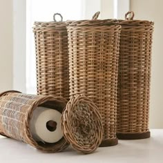 three wicker baskets with rolls of toilet paper