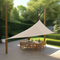 an outdoor dining area with table and chairs under a white tent on the side of a garden