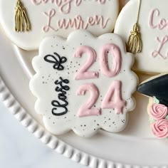 decorated cookies on a plate with graduation caps and tassels in the shape of numbers