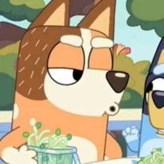 two cartoon characters are sitting at a table with food in front of them and one is looking at the camera