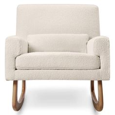 an upholstered chair with wooden legs and a cream colored fabric cover on the back